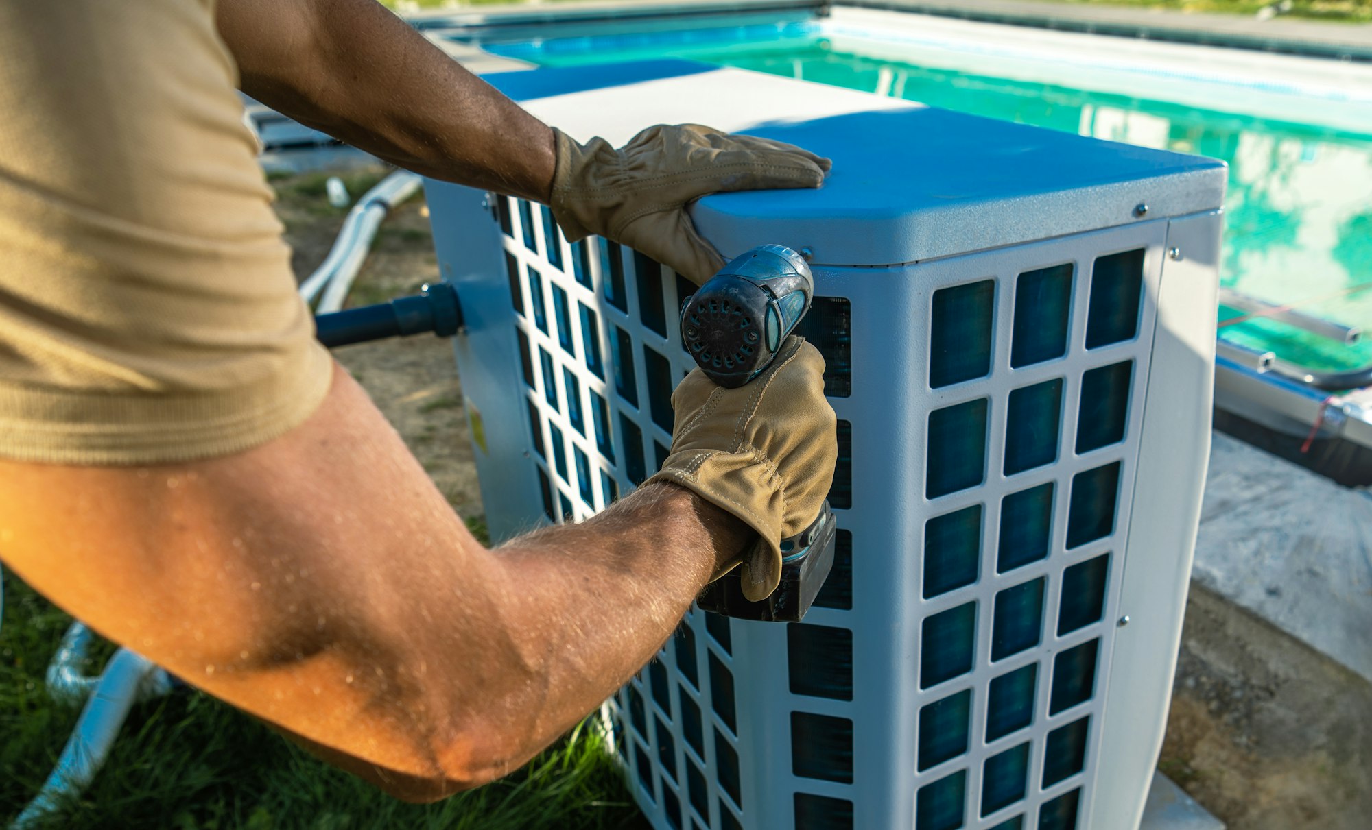 Technician Installing Pool Heater Near Swimming Pool